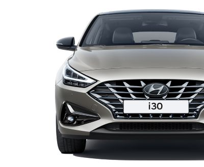 The Hyundai i30 Fastback pictured from the front, focused on the headlamp.