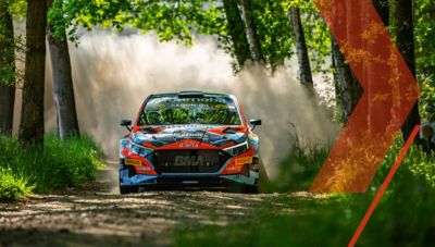 Hyundai i20 N Rally2 powering down a country road during a race.