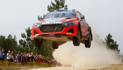 Hyundai Motorsport customer racing a Hyundai i20 N Rally2 getting air.