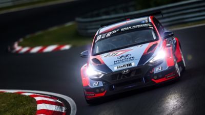 Hyundai Motorsport customer racing a Hyundai i30 N TCR in action on a racetrack.