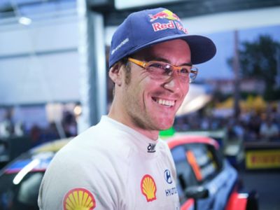 Hyundai Motorsport driver Thierry Neuville smiling with his glasses on.