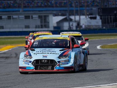 A picture of Hyundai Motorsport customer racing i30 N TCR in action on a racetrack.