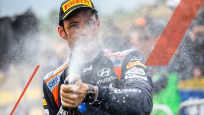 Hyundai Motorsport driver Thierry Neuville spraying champagne in celebration.