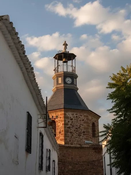 Detalle de la torre campanario con reloj y remate superior