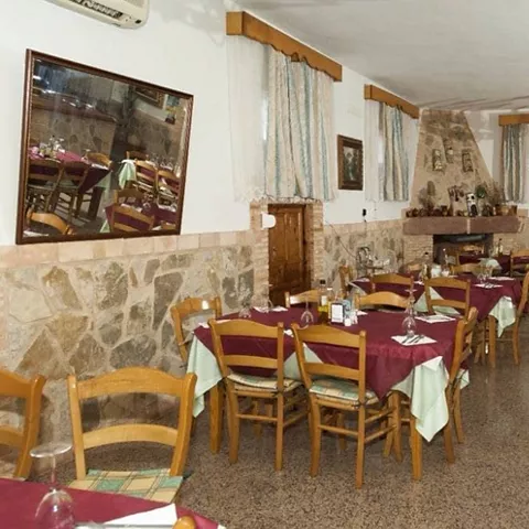 Comedor rústico con mesas vestidas y chimenea