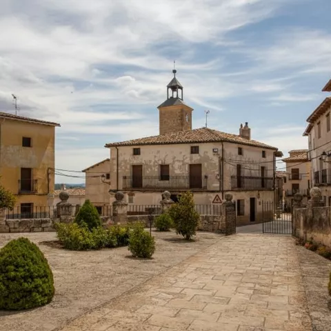 Plaza urbana con edificio histórico y jardín central