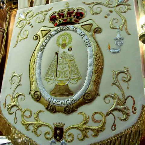 Estandarte bordado con motivos dorados y figura mariana