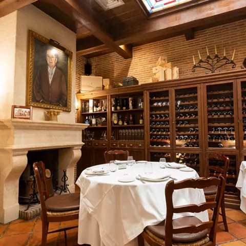 Comedor tradicional con chimenea y vinoteca