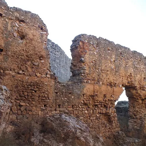 Restos de muralla de piedra entre afloramientos rocosos