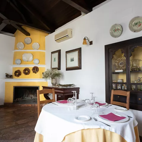 Comedor tradicional con vitrinas y techos de madera