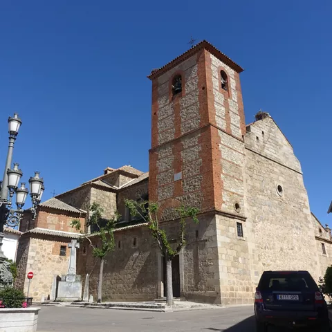 Iglesia de piedra con torre campanario y farola