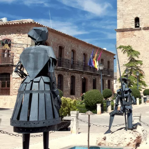 Plaza de pueblo manchego con iglesia de piedra