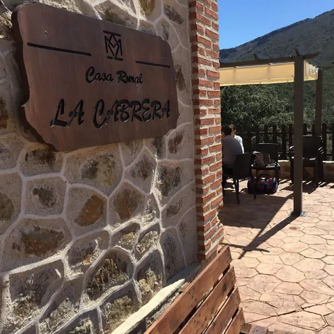 Letrero de alojamiento rural junto a terraza con vistas