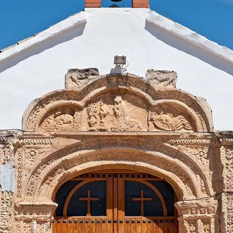 Detalle de portada religiosa con arco tallado en piedra