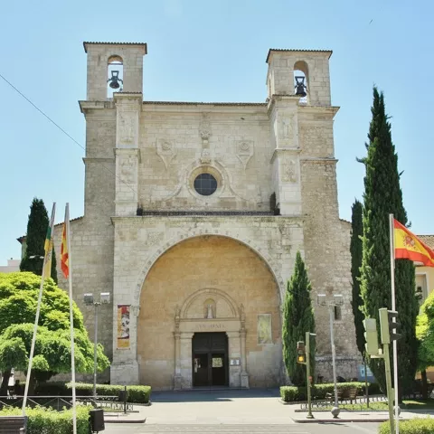 Fachada con banderas y portada de arco profundo.