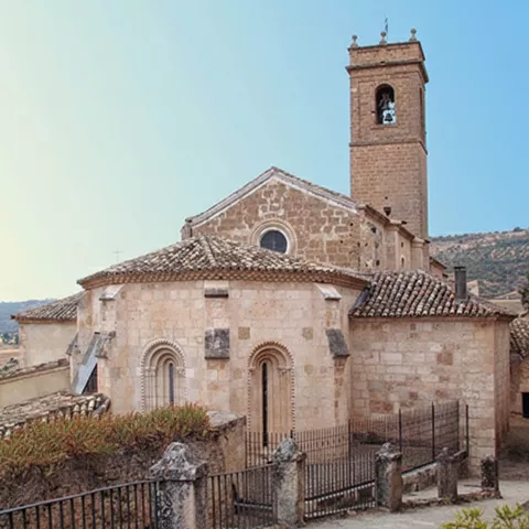 Cabecera semicircular con ventanales románicos.