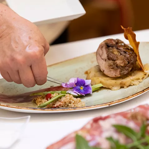 Detalle de plato gourmet con flor comestible
