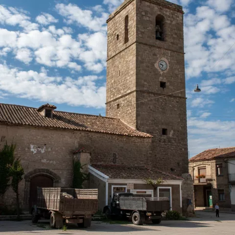 Torre de piedra junto a construcciones tradicionales