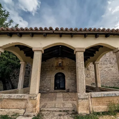 Soportal con arcos y puerta de madera.