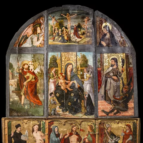 Retablo pintado con escenas religiosas y figuras.