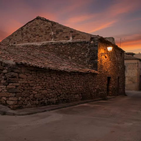Refugio excavado en roca junto a sendero.