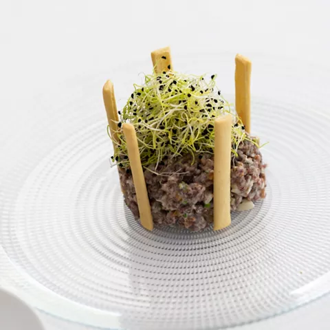Tartar presentado en plato blanco texturizado