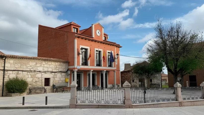 Edificio municipal de ladrillo con torre del reloj en la plaza