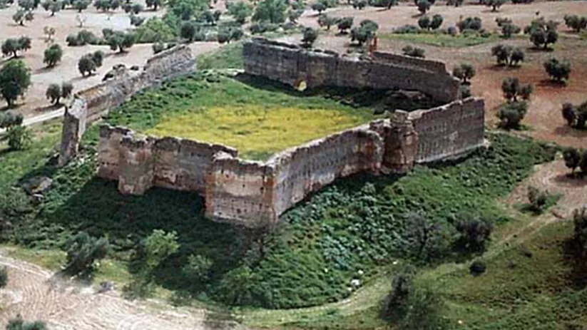 Vista aérea cenital de una fortaleza con patio interior cubierto de hierba.