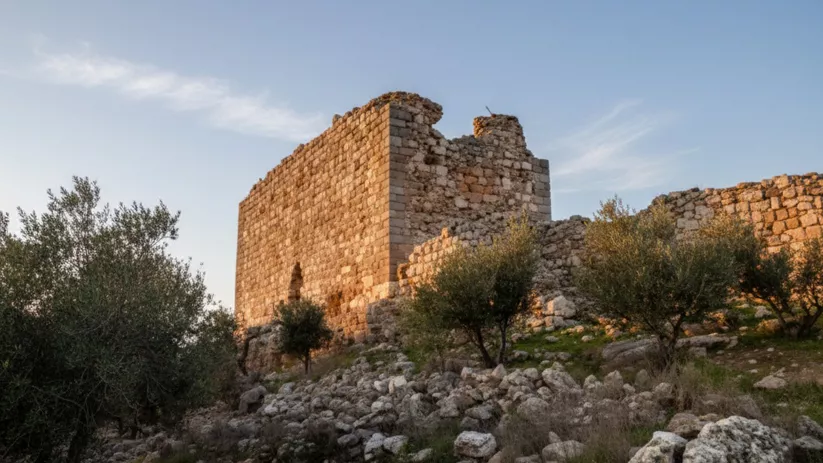 Edificación medieval en lo alto de una colina con cielo despejado.