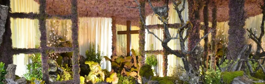 Belén floral con cruz iluminada