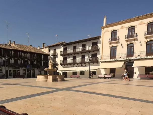 Plaza amplia con bancos y fuente central