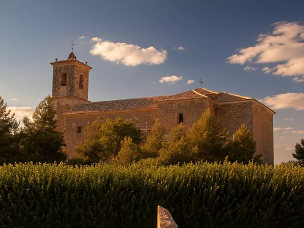 Iglesia de piedra entre árboles y vegetación
