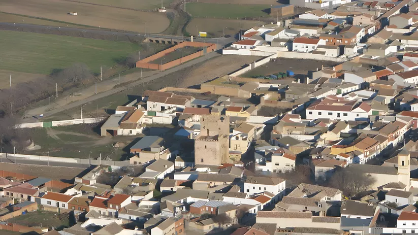 Vista aérea de pueblo con torre fortificada en el centro