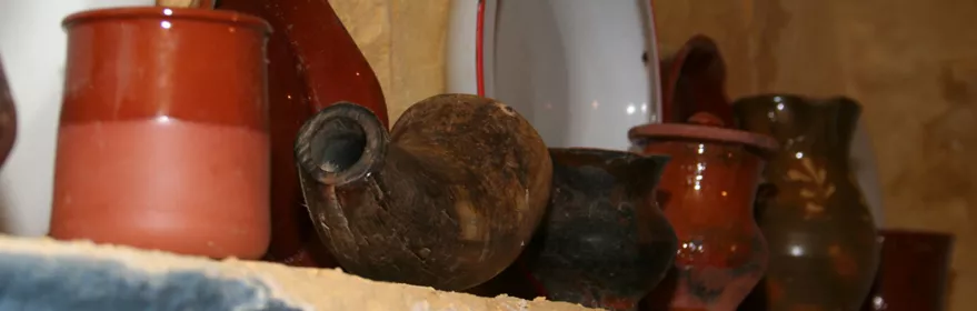 Detalle de vasijas y platos sobre repisa