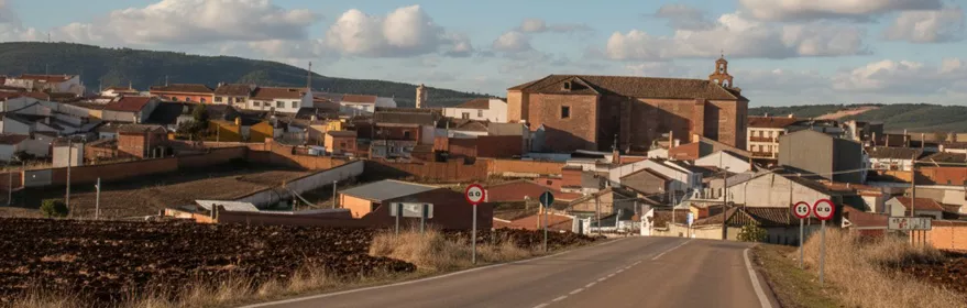 Vista de Castellar de Santiago desde la carretera de acceso con la iglesia parroquial destacando sobre el casco urbano.