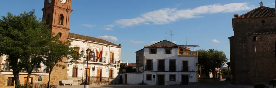 Plaza amplia con ayuntamiento, torre del reloj e iglesia