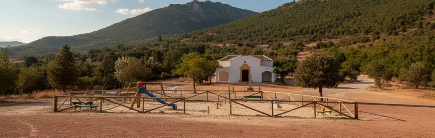 Ermita pequeña en paisaje rural con zona de juegos