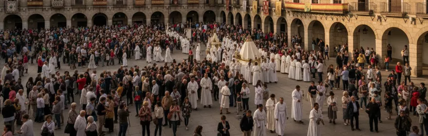 Plaza histórica llena de público durante procesión con participantes vestidos de blanco.