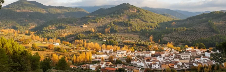 Vista panorámica de un pueblo entre montañas y olivares
