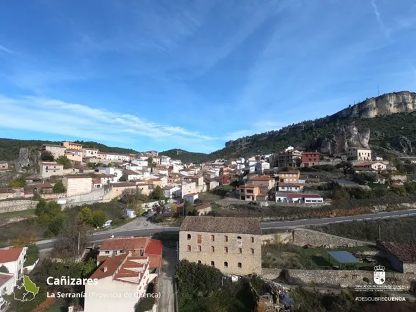 Vista general de un pueblo entre montañas rocosas.