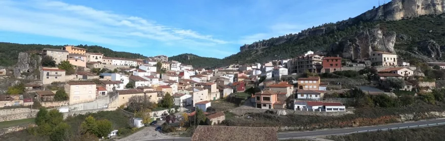 Vista general de un pueblo entre montañas rocosas.