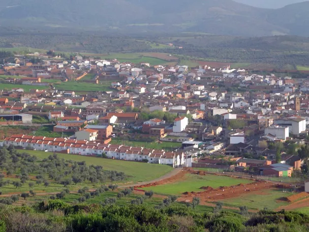 Vista panorámica de un pueblo rodeado de campos y colinas