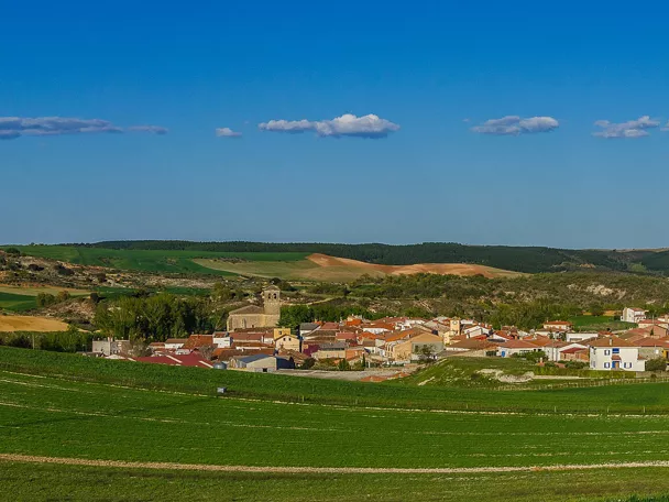 Vista panorámica de un pueblo rodeado de colinas y campos.