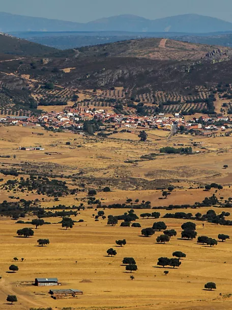 Vista panorámica del caserío rodeado de dehesa y colinas suaves
