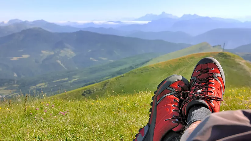 Botas de senderismo con vistas a montañas y valle