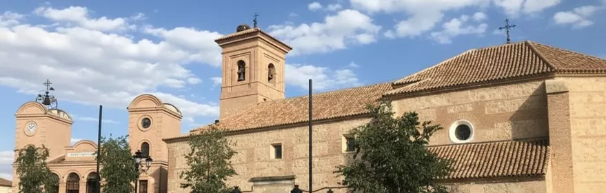 Iglesia de piedra junto a un edificio con reloj