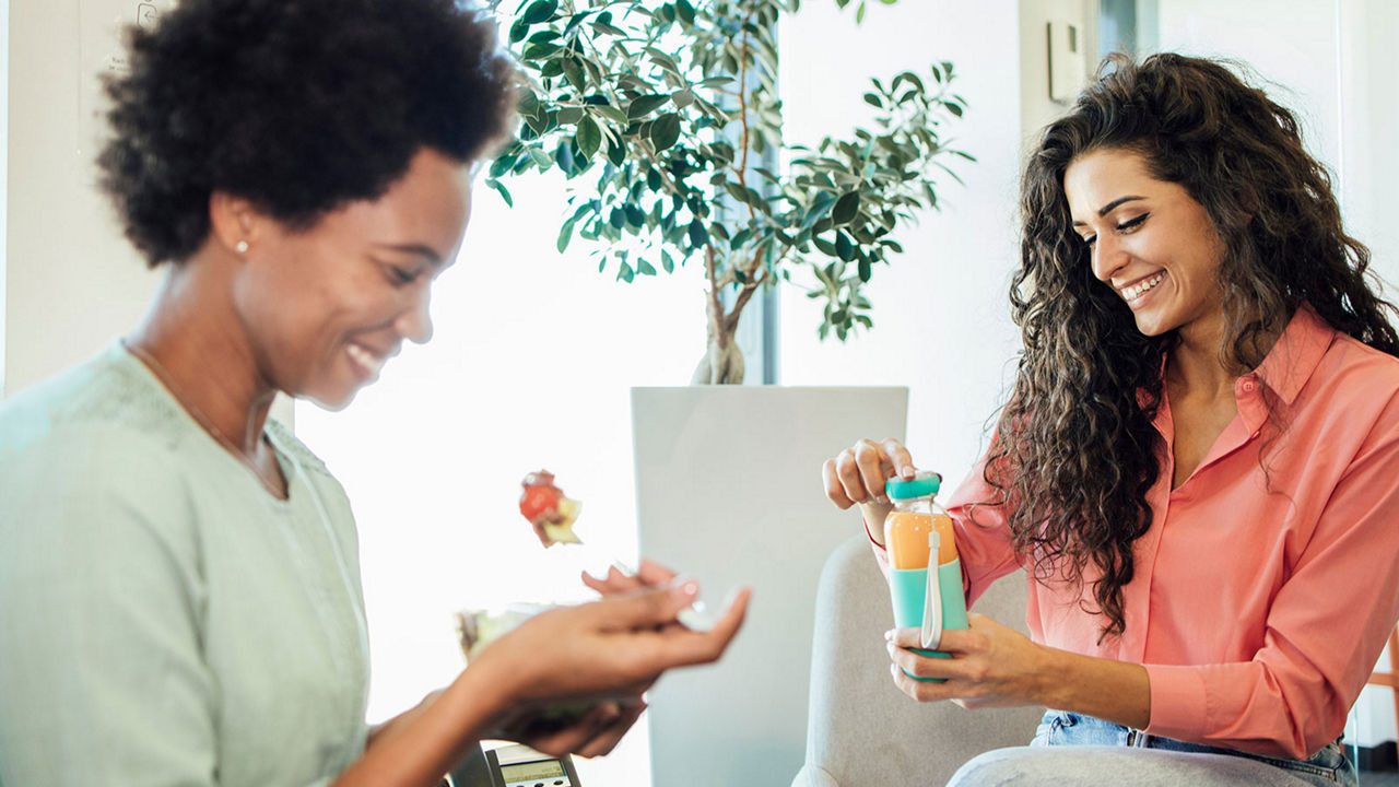 Two women enjoying healthy beverages at work