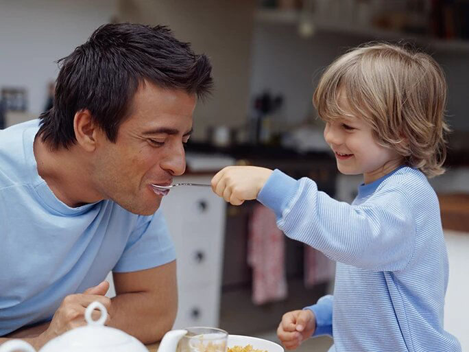 father and son eating breakfast