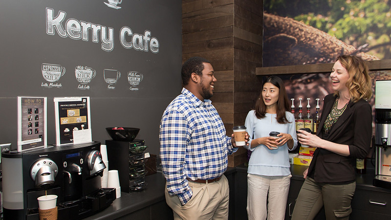 Employees talking in café