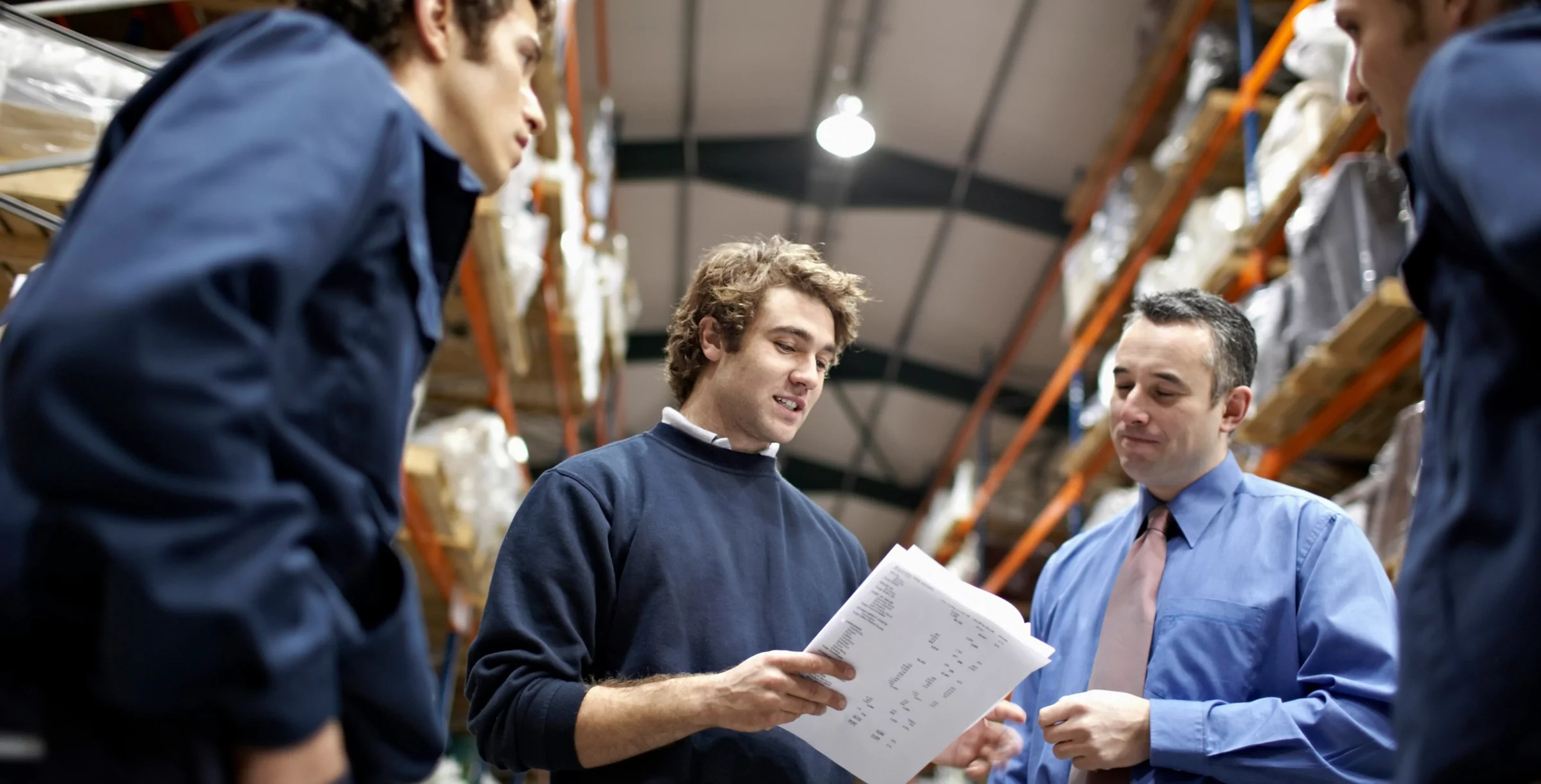 Manager and workers in warehouse